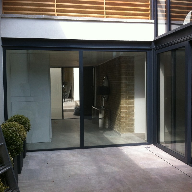 Floor-to-ceiling sliding doors opening to courtyard in Bicester