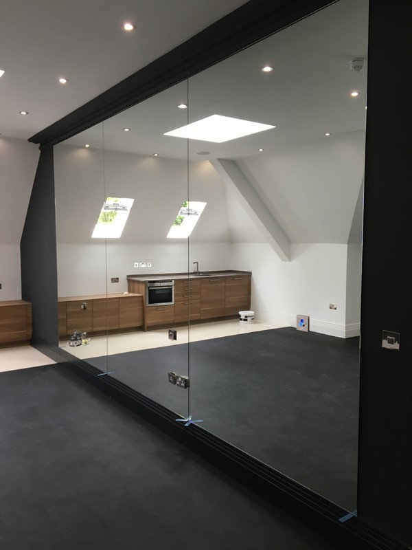 Frameless glass partition in loft conversion by Bicester glaziers