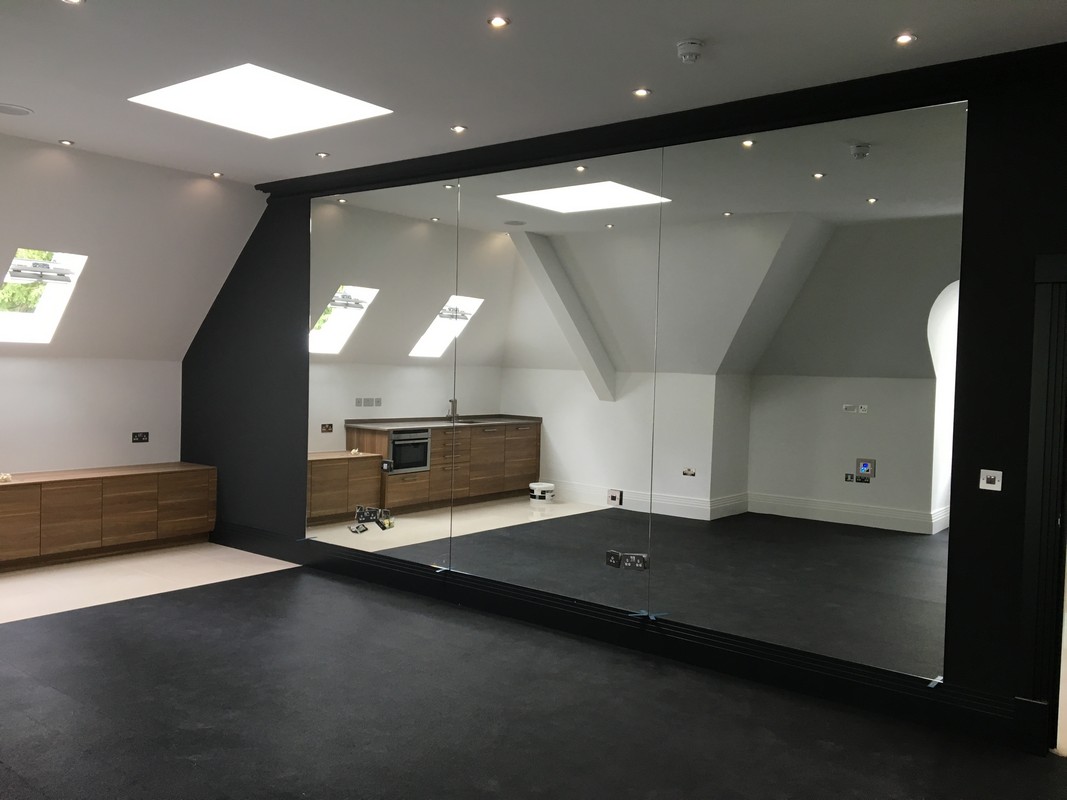 Frameless glass wall dividing loft conversion in Bicester